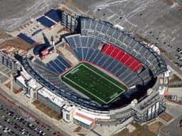 Boston / Foxboro — Gillette Stadium: aerial view of an open stadium with a green field and surrounding parking.