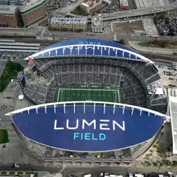 Seattle — Lumen Field: aerial view of a stadium with "Lumen Field" signage on the roof.