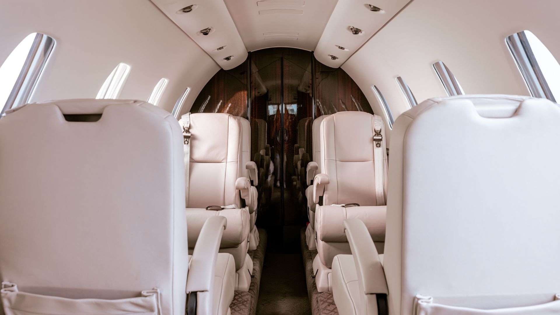 Interior of a private jet with cream-colored leather seats