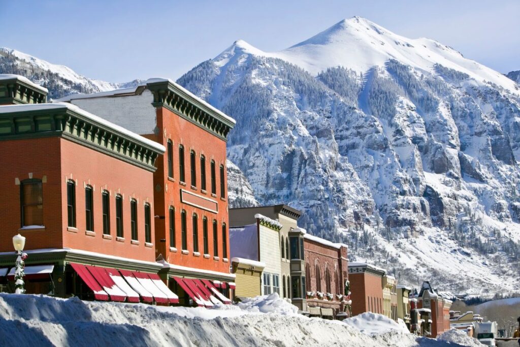 The picturesque main street of Telluride, Colorado, is set against the backdrop of the Rocky Mountains.