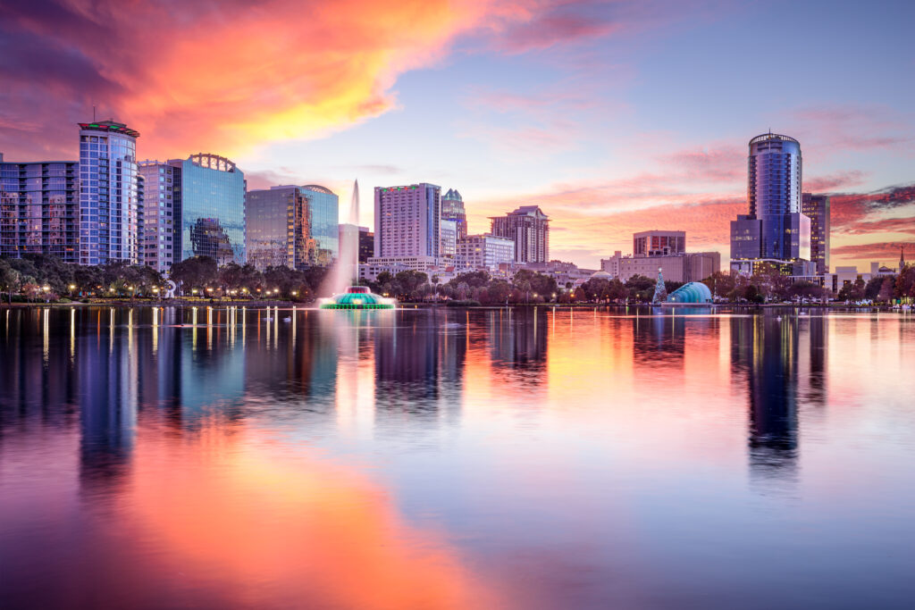 A stunning sunset over the city skyline and lake in Orlando, Florida.